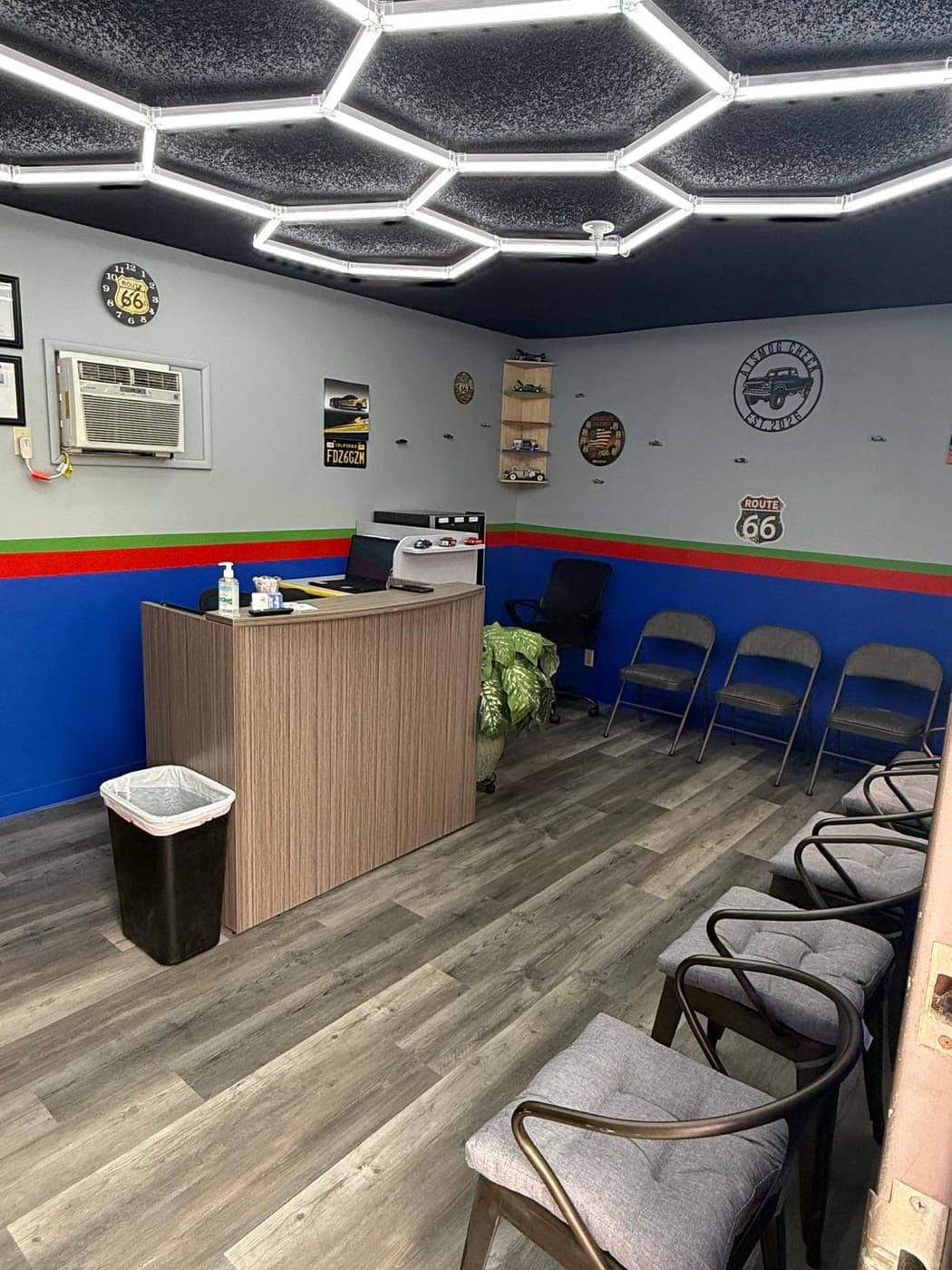 Front counter in the waiting room with Route 66 signs and an A1 Smog Check truck sign on the wall